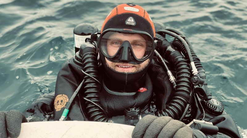 Dusty Klifman on the surface of the water with his SCUBA gear